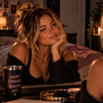 Confident woman smiling at herself in a vanity mirror, representing the self-respect that comes from recognizing your worth, raising your standards, and refusing to settle for less than you deserve.