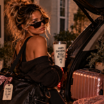 Woman packing her belongings into an SUV and looking back with a confident expression, representing the difficult but necessary decision to leave behind a relationship that costs you your peace.